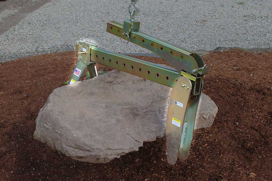 Boulder Grab Attachment lifting large rock from ground