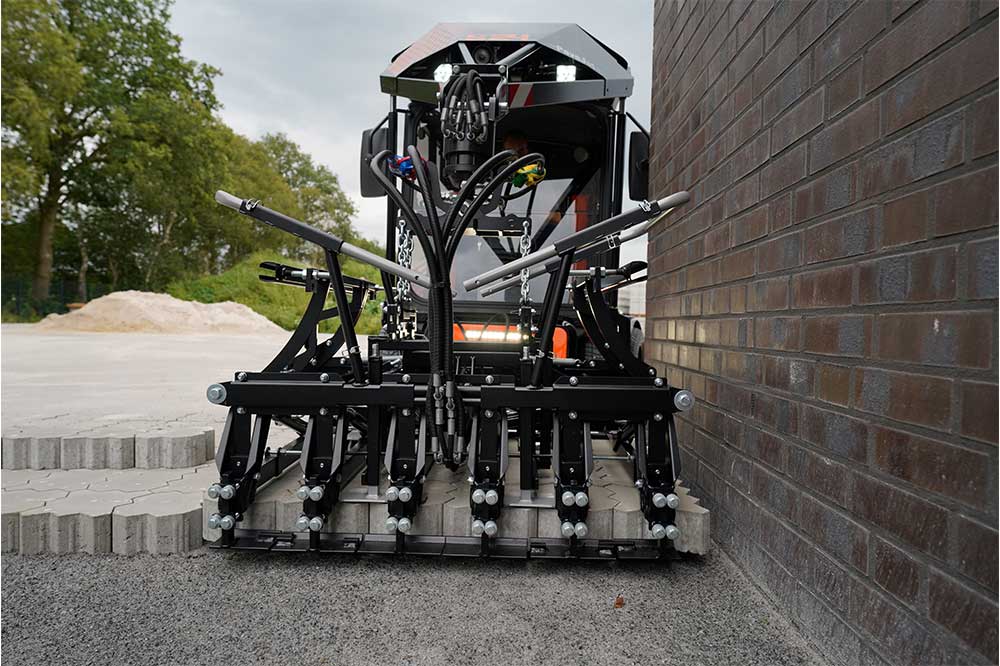An orange and black S24 PaveJet paver laying machine laying pavers
